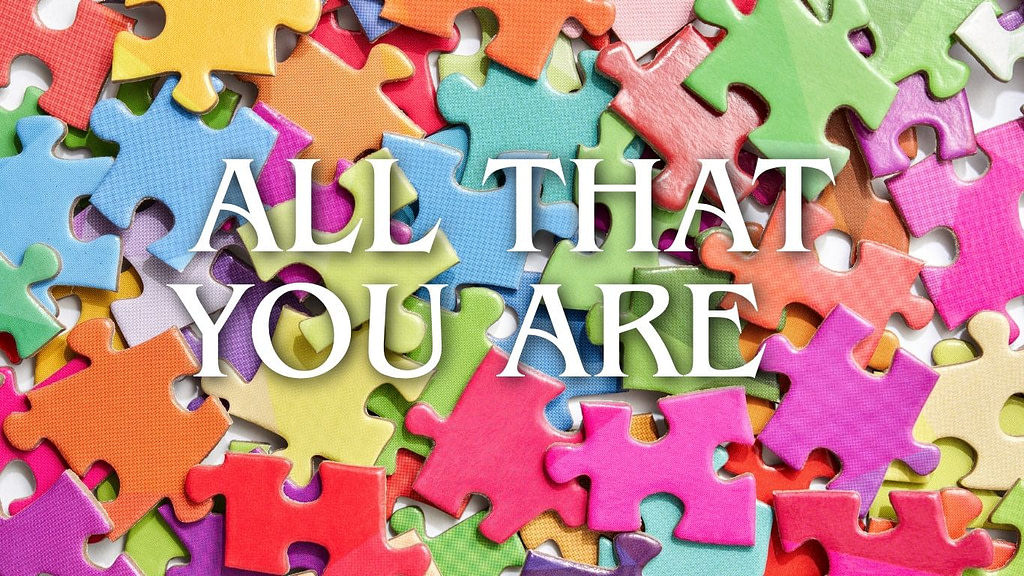 Colorful puzzle pieces with the words “All That You Are,” symbolizing living in your skin, self-acceptance, authenticity, and embracing every part of yourself.