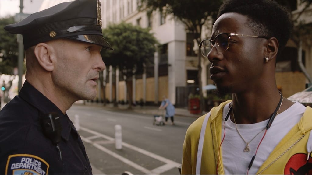 Officer Merk (Andrew Howard) confronts Carter (Joey Bada$$)